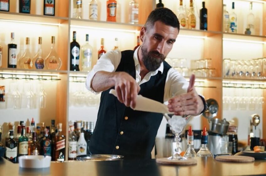 Bartender making martini